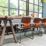Wooden dining table with chairs and bench in stylish interior