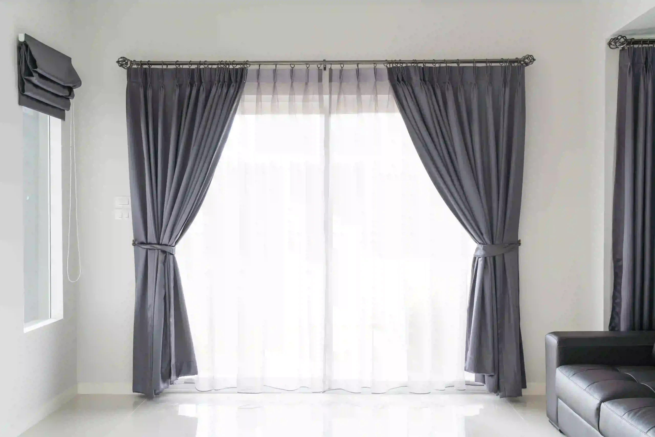 Long curtains touching the floor in a stylish bedroom interior