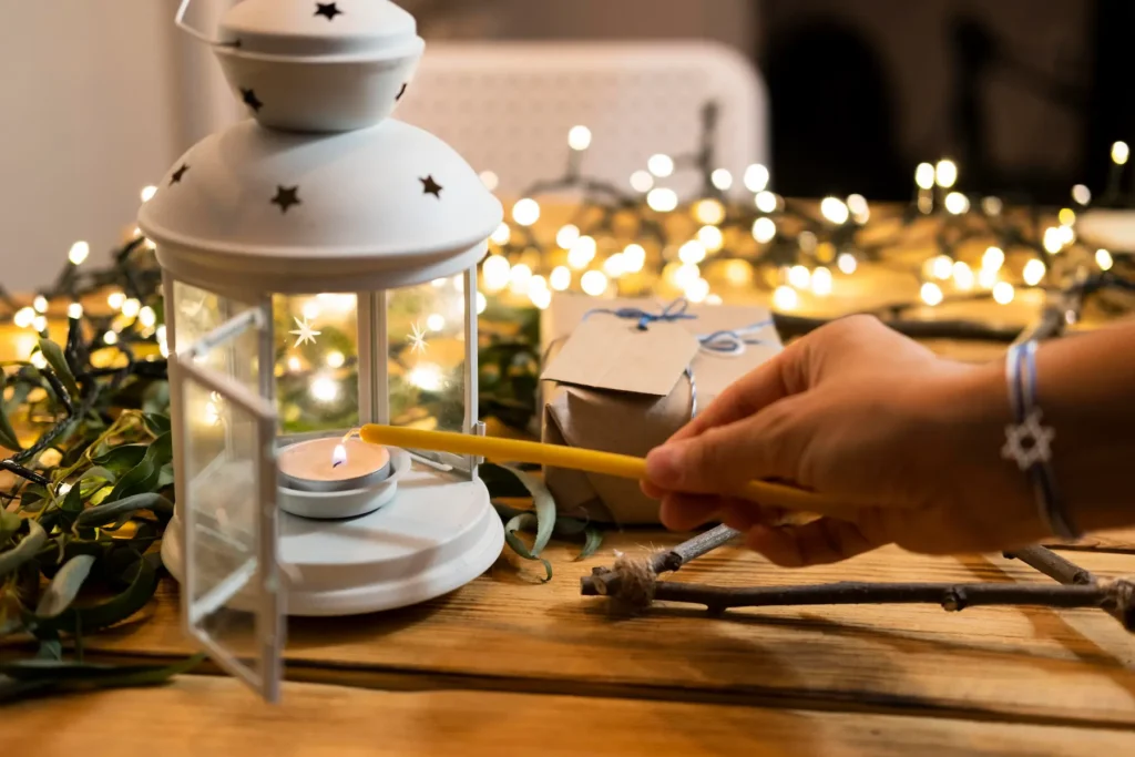 A warm, glowing oil lantern placed on a rustic wooden table during an evening outdoor gathering, showcasing how the soft amber light creates a cozy and inviting atmosphere for camping or backyard events.