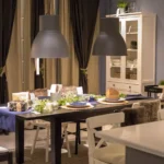 Modern dining table setup with pendant lights and decor