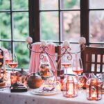 Beautifully decorated birthday dinner table with candles, wine glasses, and floral centerpiece