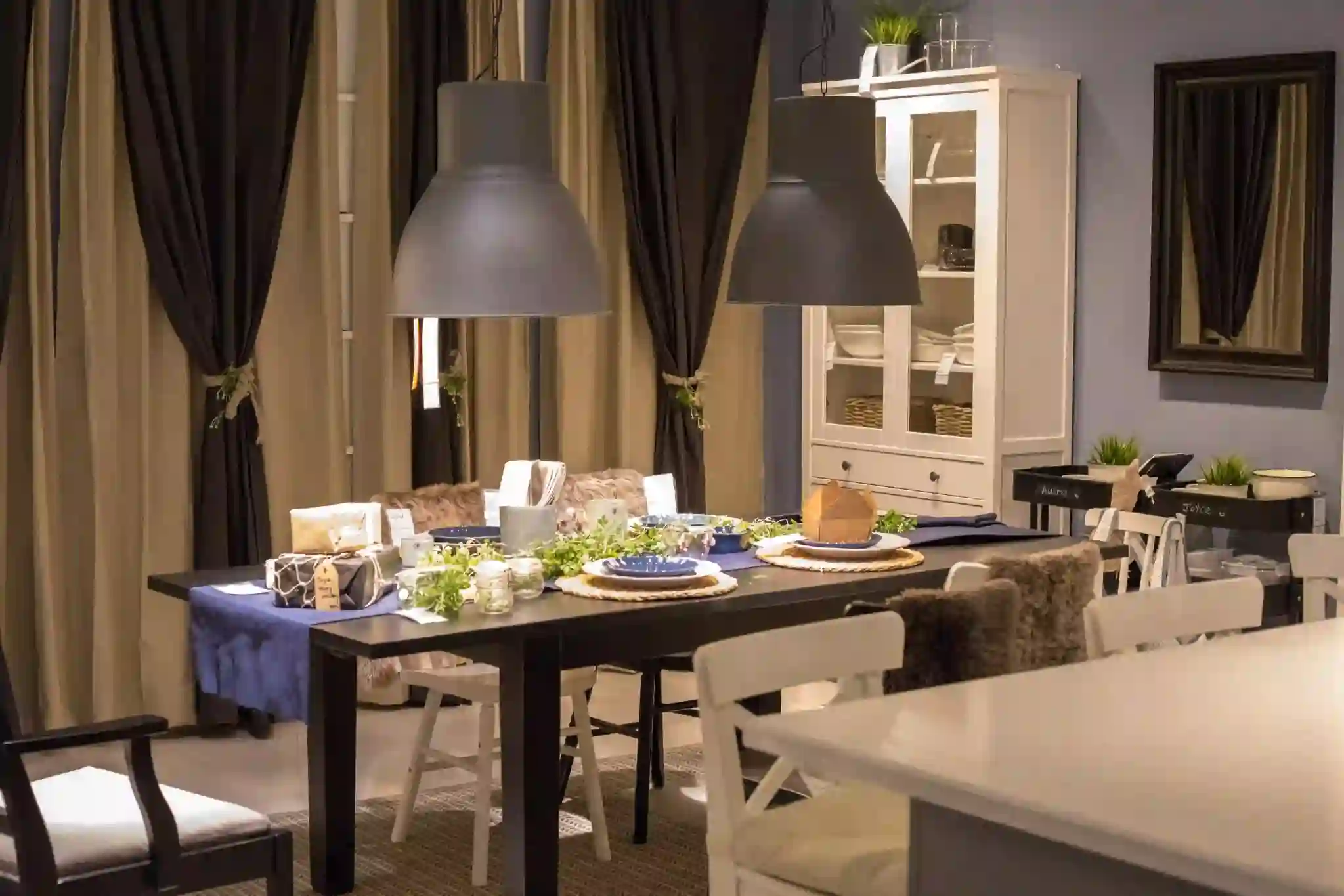 Stylish pendant lights matching modern kitchen decor with elegant cabinets, marble countertops, and a contemporary interior design.