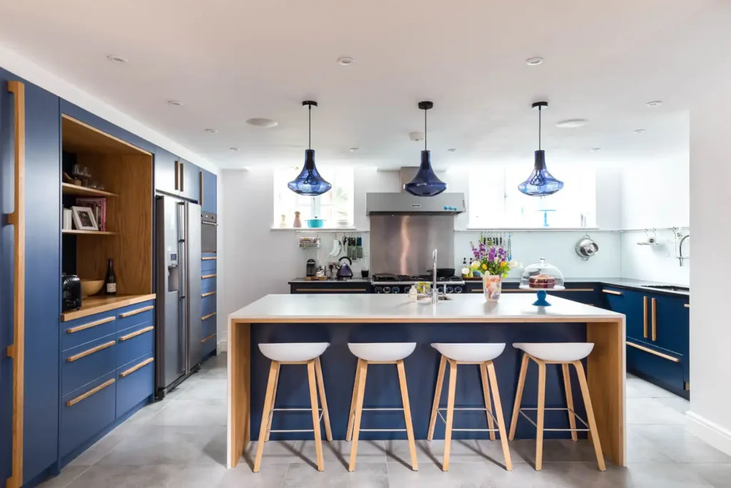 Hanging pendant lights arranged in a row above kitchen island
