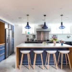 Hanging pendant lights arranged in a row above kitchen island